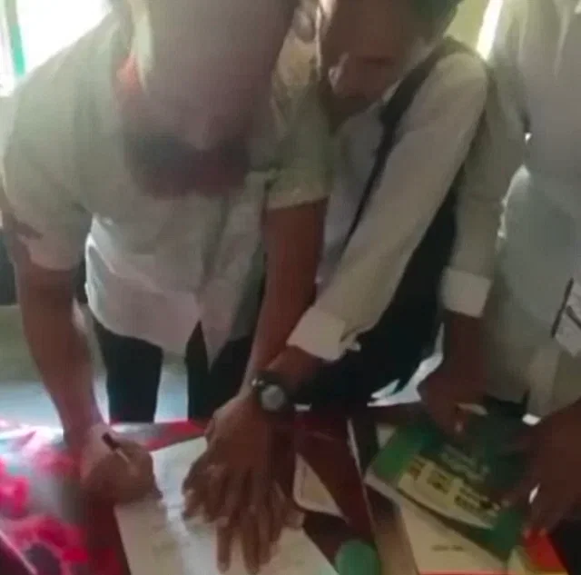 Principal Obaidur Rahman sings his resignation paper at his college in Faridpur on 5 September, 2024.